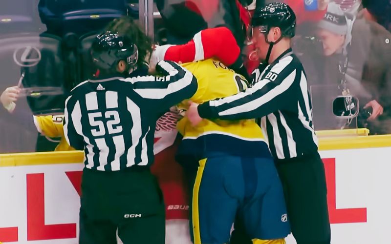referees separate players during a fight